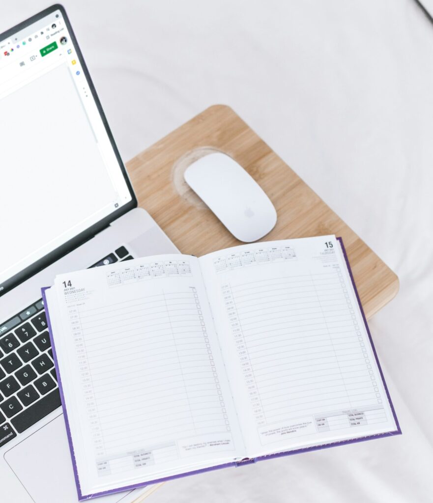 Organized workspace with laptop and planner for back-office business support